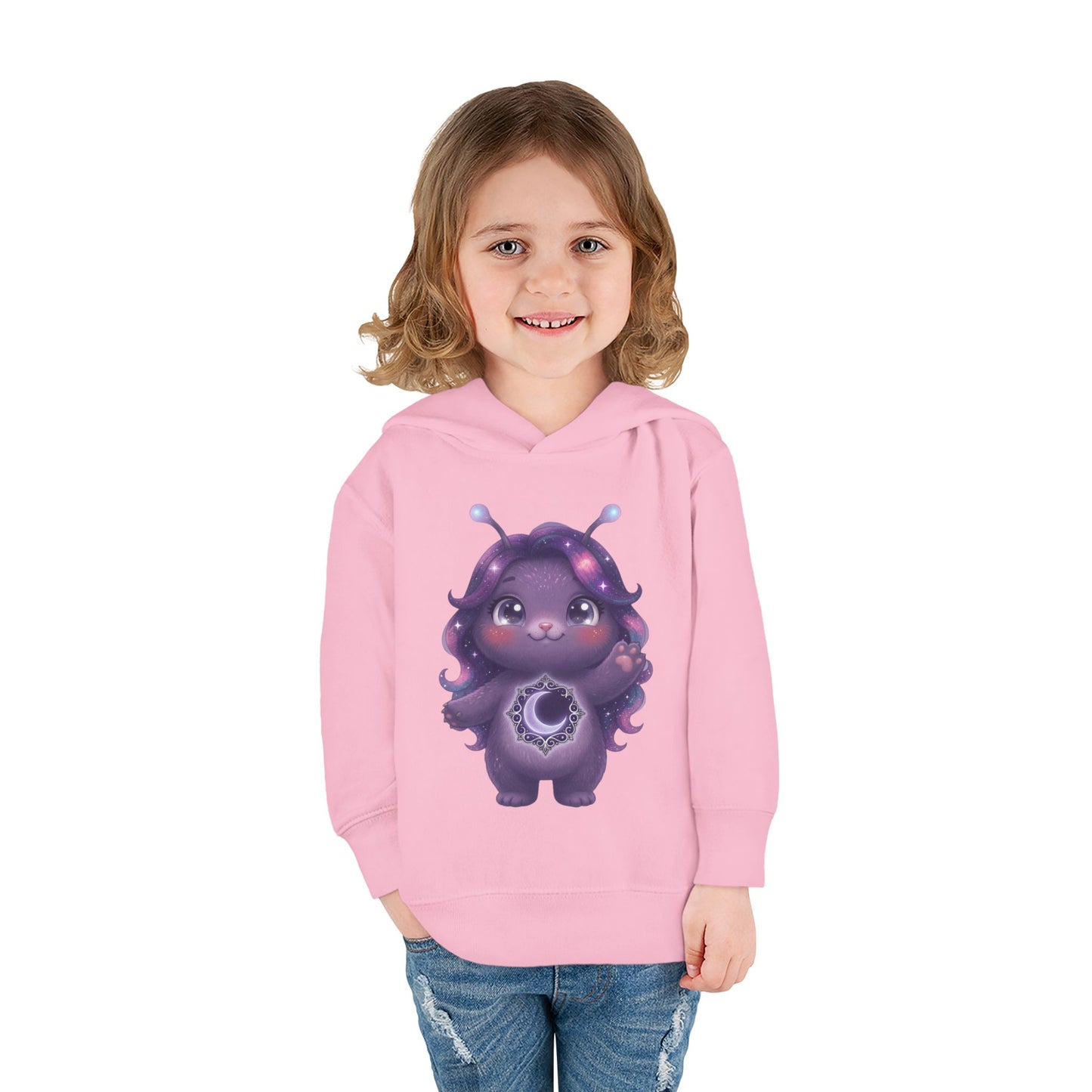 Light pink hoodie featuring a cute purple galaxy creature with antennae, long wavy hair, and a glowing crescent moon emblem on its chest.